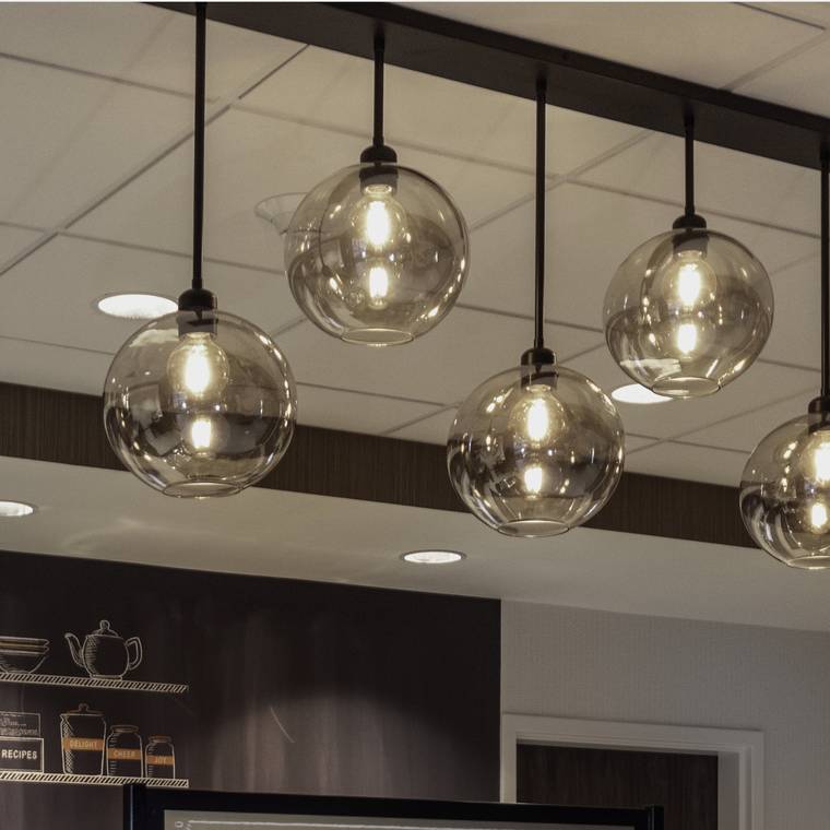 Six smoked-glass globe pendants above the breakfast bar at Conway.