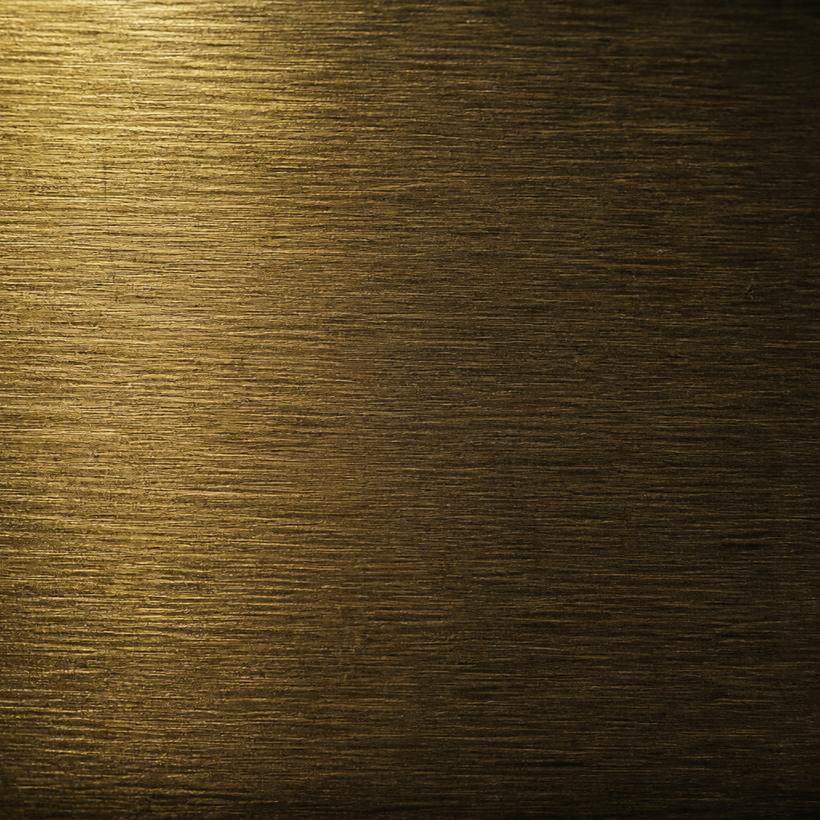 Brushed brass metal material sample.