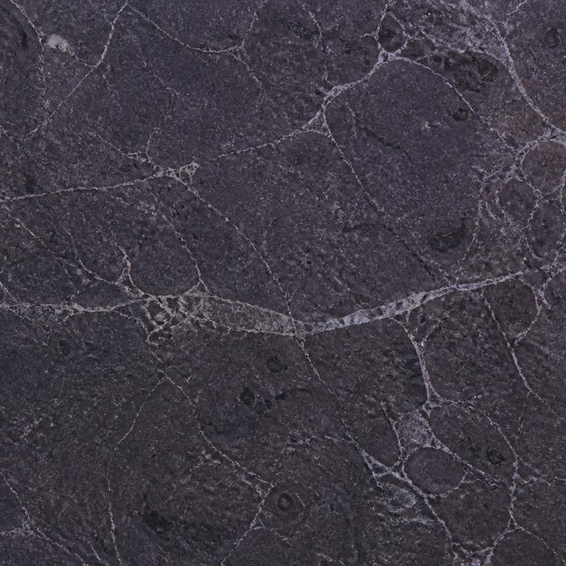 Dark veined stone material sample.