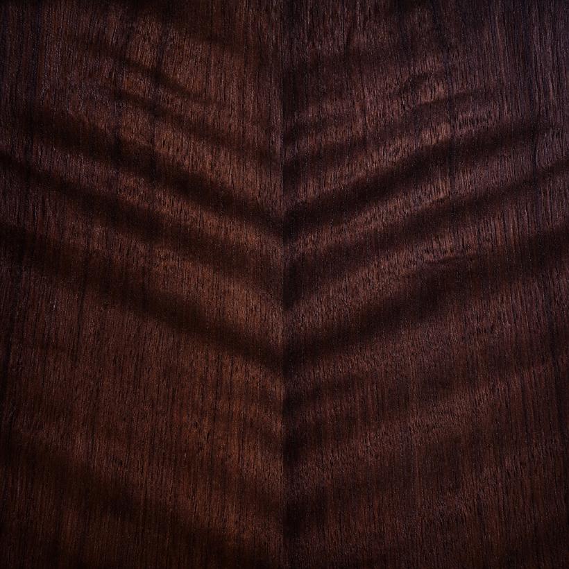 Book-matched walnut veneer material sample.