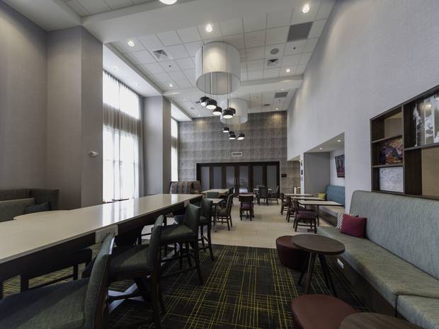 Communal dining table, upholstered bar chairs and banquette seating in the great room at Conway.